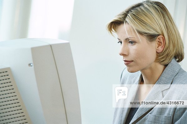 Businesswoman using desktop computer