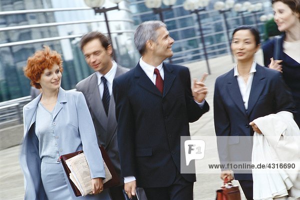 Group of business executives walking in business park