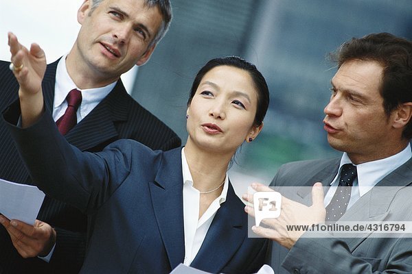 Business associates  woman in foreground gesturing