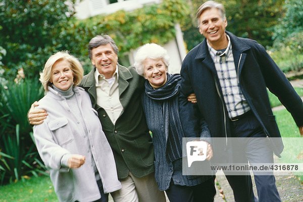 Two senior couples walking outdoors  front view
