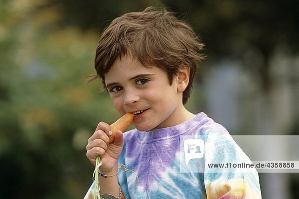 Young Boy Sitting Outside Eating Carrot SC AK Summer Anchorage