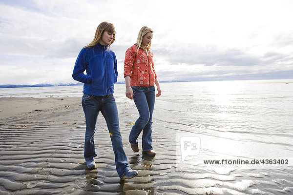 Two young women walk along Bishop's Beach in Homer  Alaska