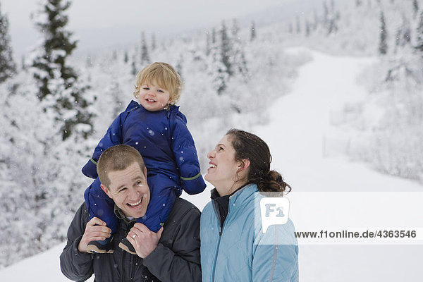 Couple take young son for an outdoor walk during Winter in Pedro Bay  Alaska.