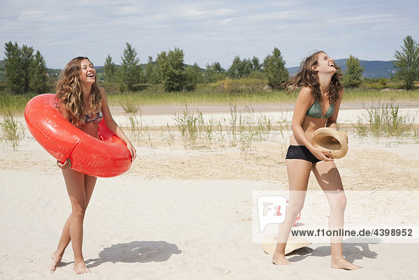 Young women laughing on the beach