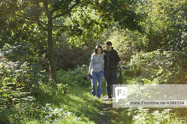 Man and woman walking in park