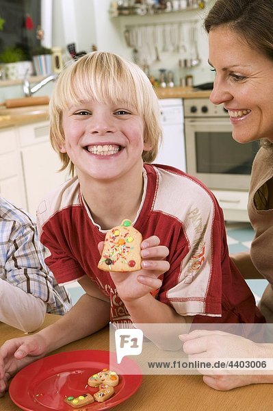 Boy showing a biscuit he made himself