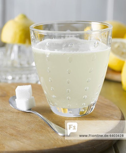 Hot lemon with sugar cubes  lemons in background