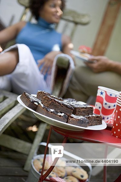 Brownies at a garden party for 4th of July  woman in background