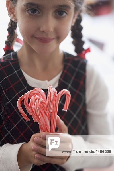 Girl holding candy canes
