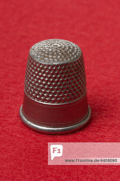 Thimbles on red background