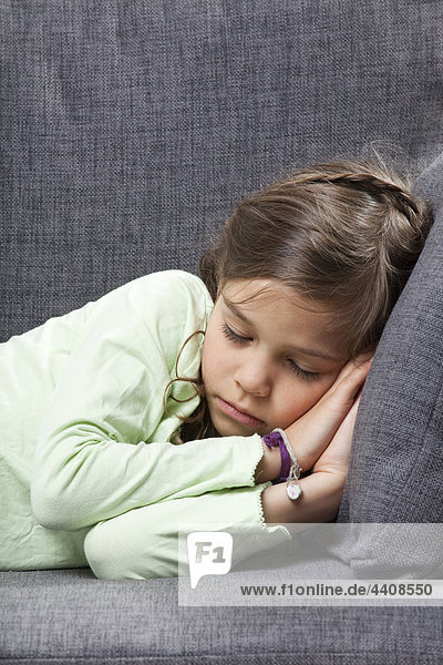 Girl (6-7) sleeping on couch