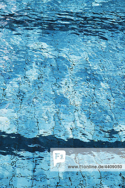 Water rippling in swimming pool close up