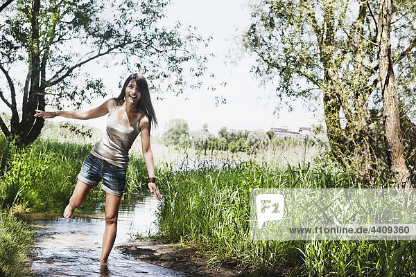 Young woman standing in creek