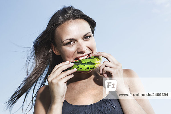 Junge Frau isst Wassermelone  Portrait
