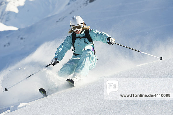 Austria,  Woman skiing on arlberg mountain,  smiling