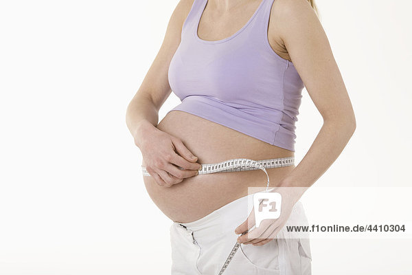 Pregnant woman measuring stomach  mid section