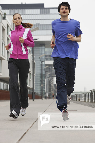 Young man and woman jogging