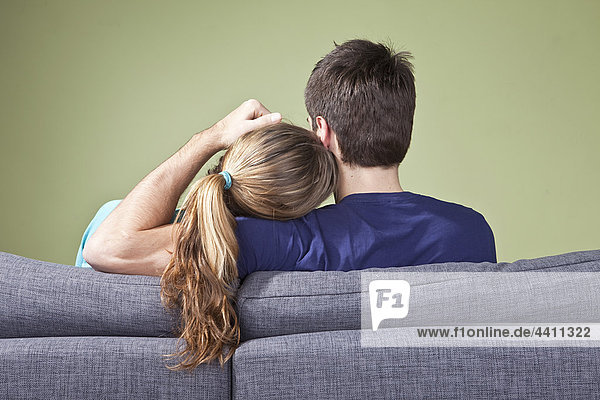 Junges Paar auf der Couch  Rückansicht