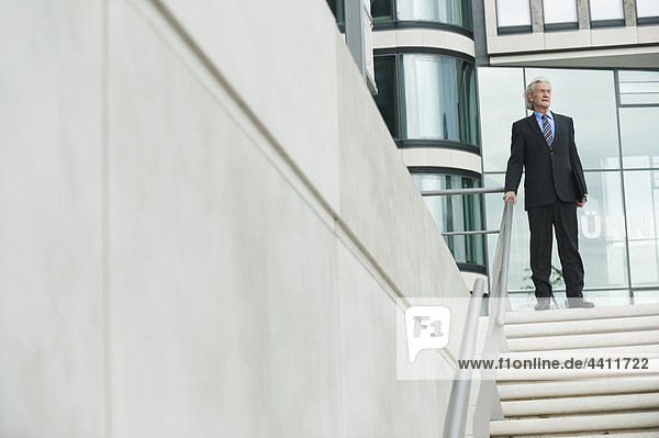Germany  Hamburg  Businessman standing at steps