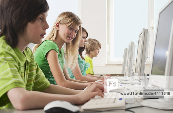 Germany  Emmering  Students (12-14) using computer in computer lab