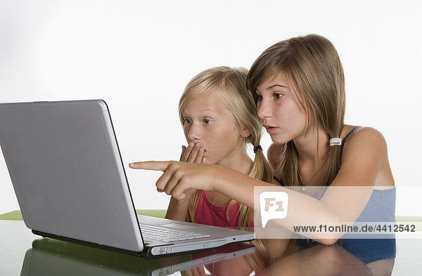 Two girls (10-11) looking at laptop