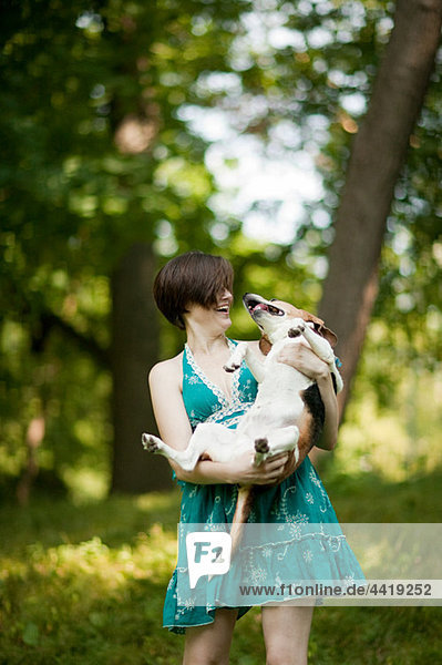 Woman holding her pet beagle