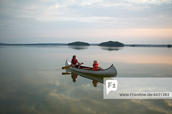 Mother with daughter in rowing boat