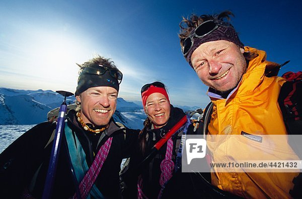 Party of skiers posing for portrait in mountain scenery