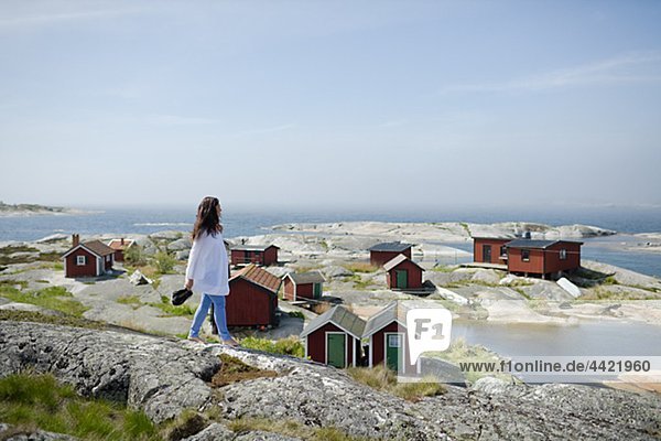 Woman walking on rock  cottages in background