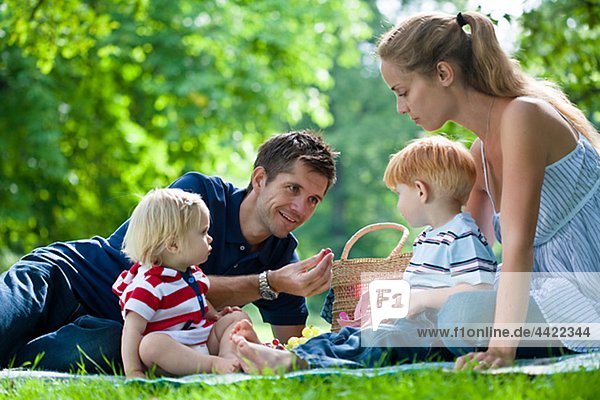 Mid adult parents with children on picnic