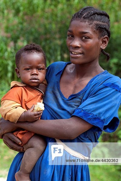 Half body shot of young lady holding her baby daughter in the arm  Mizan Tefari  Ethiopia  East Africa.