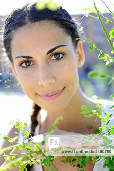 Portrait of attractive young spanish woman in nature