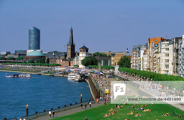 Germany  North Rhine Westphalia  Dusseldorf. A View over the Rheinuferpromenade along the Rhine river and the old city with the Lambertus Church castle tower. .