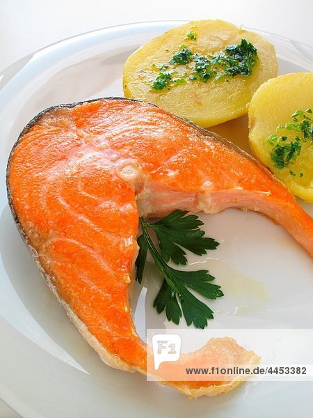 Salmon fillets grilled  with boiled potatoes  olive oil and parsley