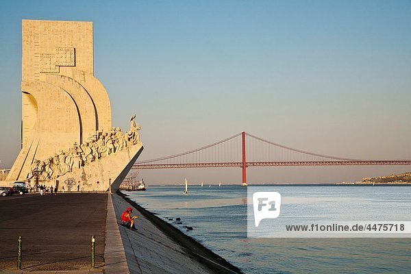 Monument to the Discoverers and 25 April Bridge  in Belem  Lisbon  next to the mounth of Tagus river in Atlantic Ocean Portugal