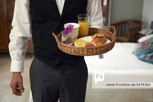 Waiter with breakfast tray