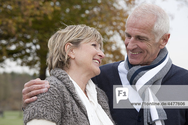 Laughing couple outdoors in autumn