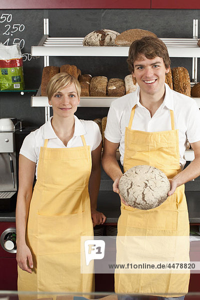 Two sales clerks in a bakery cafe