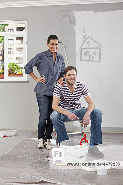 A young man and woman renovating an apartment