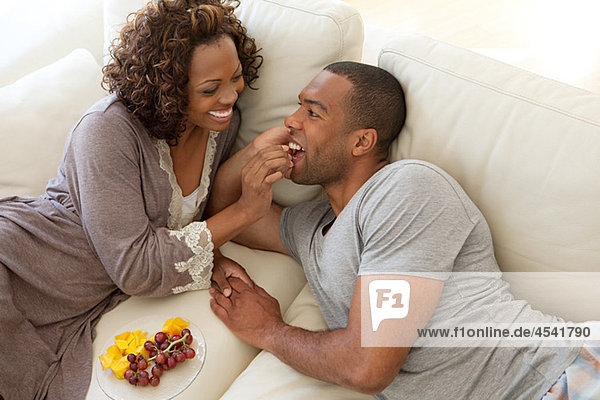 Woman feeding grapes to boyfriend