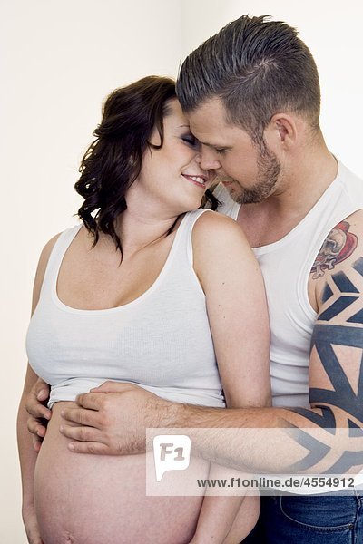 Man embracing pregnant woman