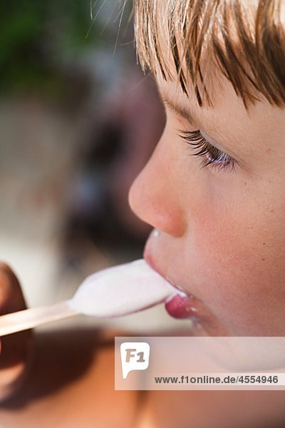 Profile of boy eating ice cream