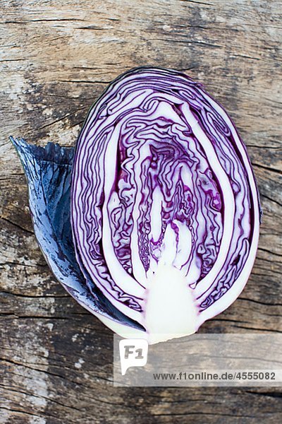 Overhead view of half of red cabbage on wooden table