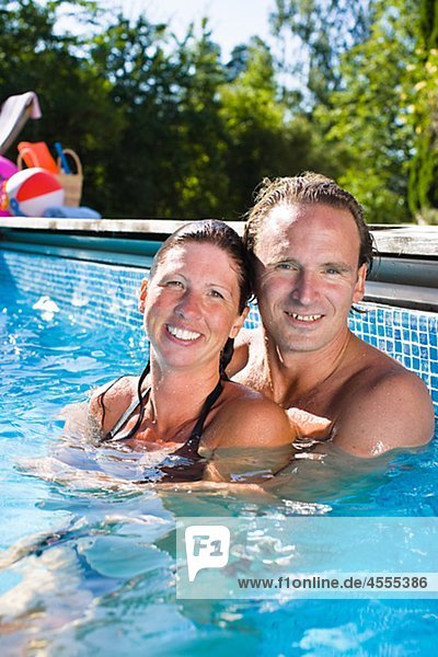 Portrait of embracing couple in swimming pool