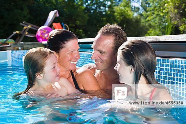 Couple with children in swimming pool