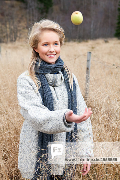 Portrait of teenage girl wearing scarf in field
