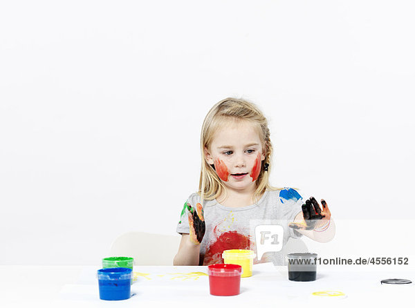Girl playing with finger paint