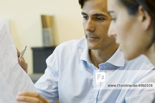 Businessman reviewing contract with client