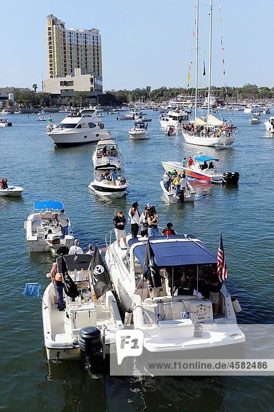 Crowd with boats downtown Tampa Gasparilla Pirate Festival