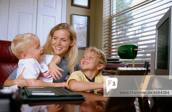 mother with kids in a home office